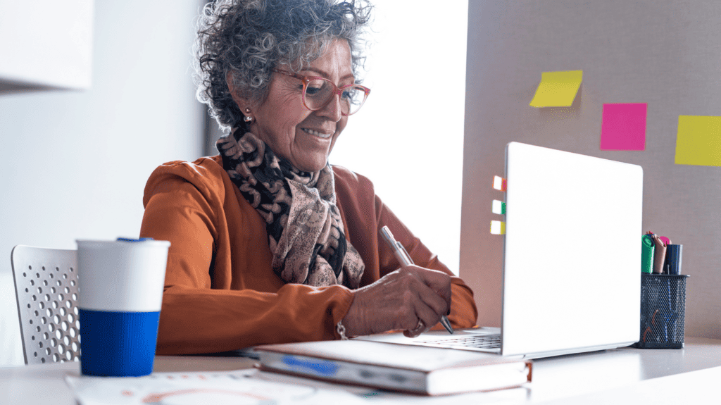 Older woman working at laptop.