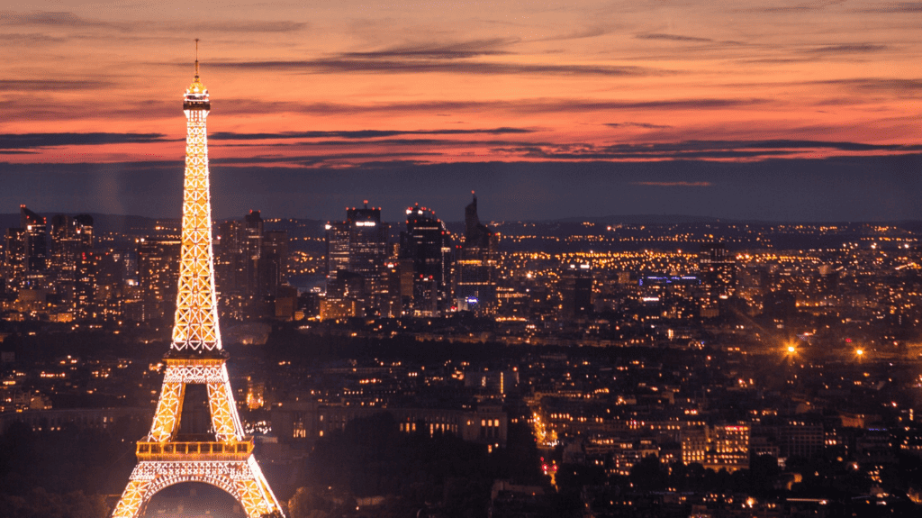 Eiffel Tower lit up at sunset in Paris France