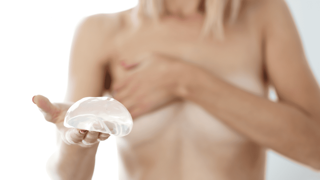 Image of woman holding a breast implant