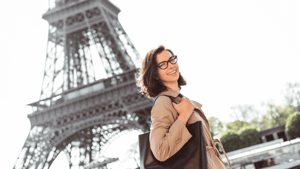 Woman walking in front of Eiffel Tower in Paris France